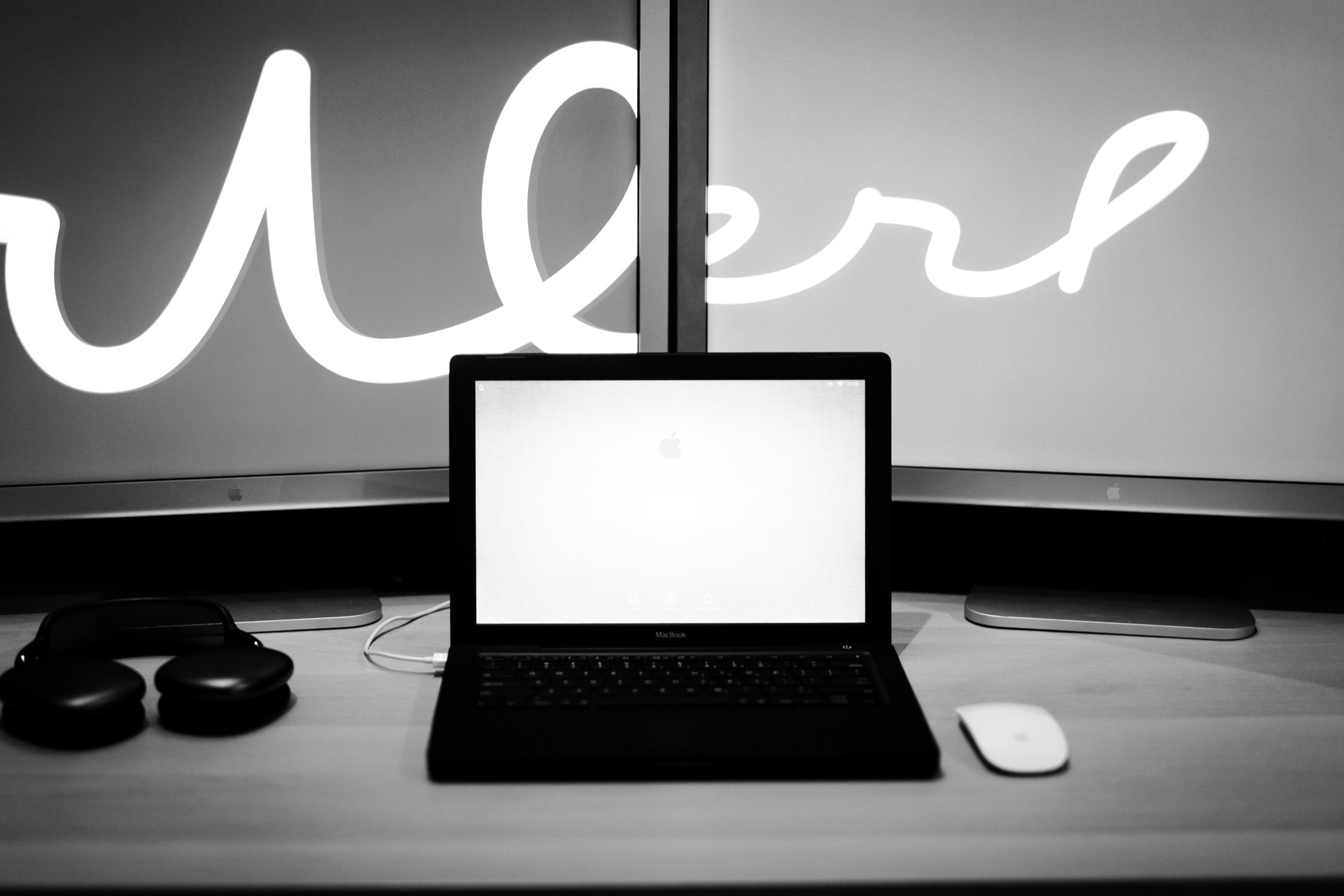The MacBook against a backdrop of two 30" Apple Cinema Displays
